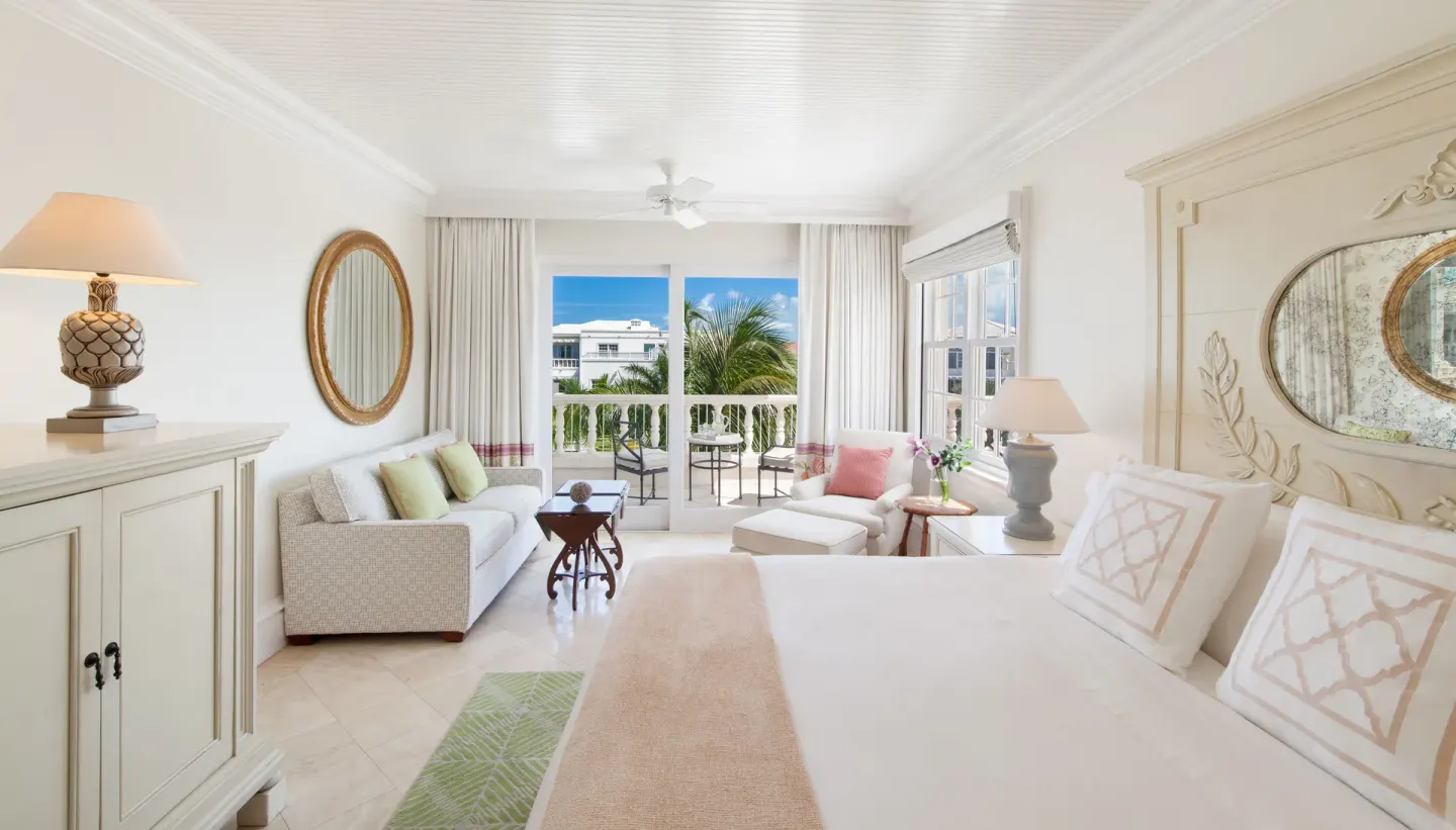 Junior Suite king bed and sitting area with balcony at The Palms Turks and Caicos.