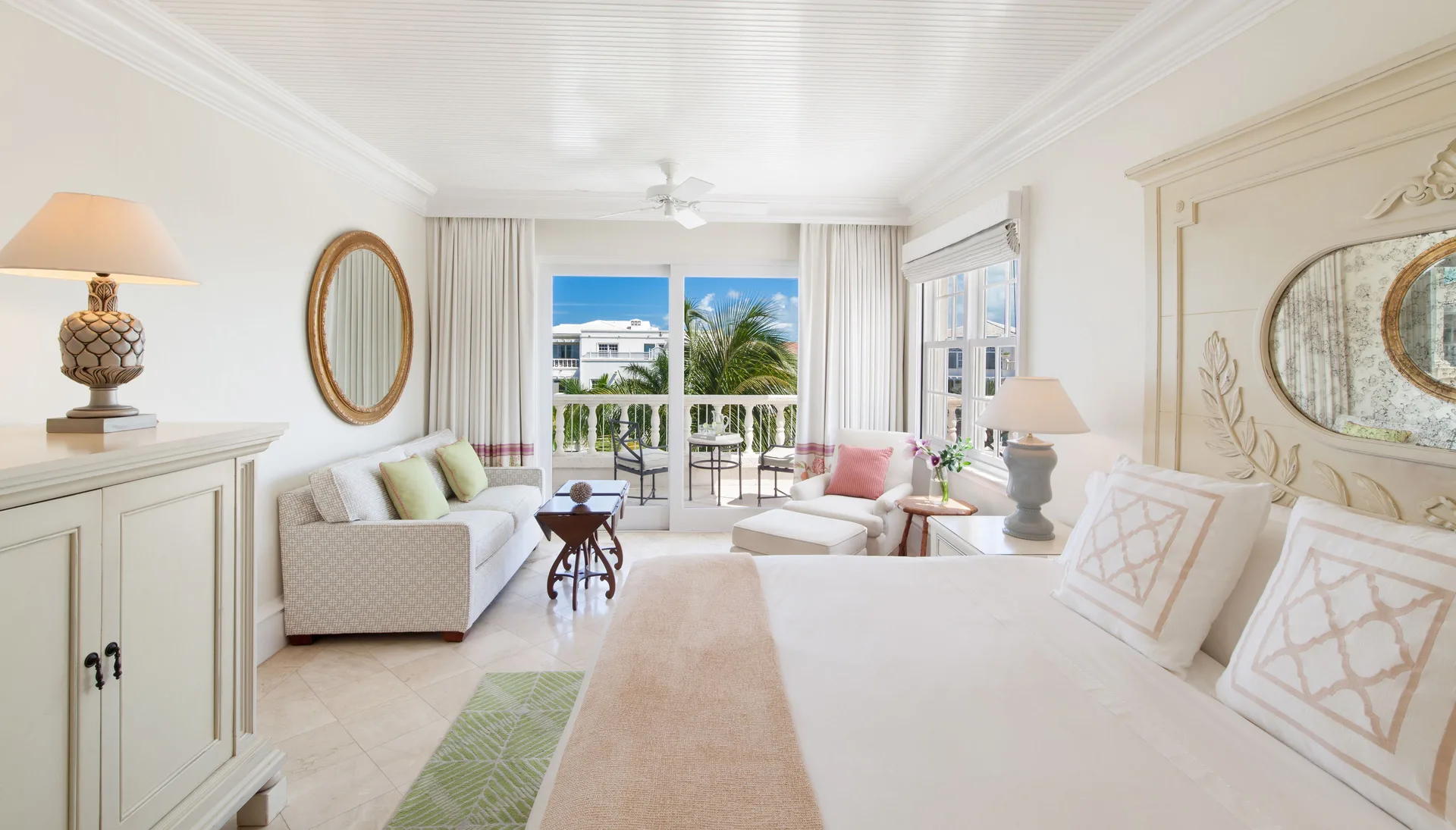 Junior Suite king bed and sitting area with balcony at The Palms Turks and Caicos.