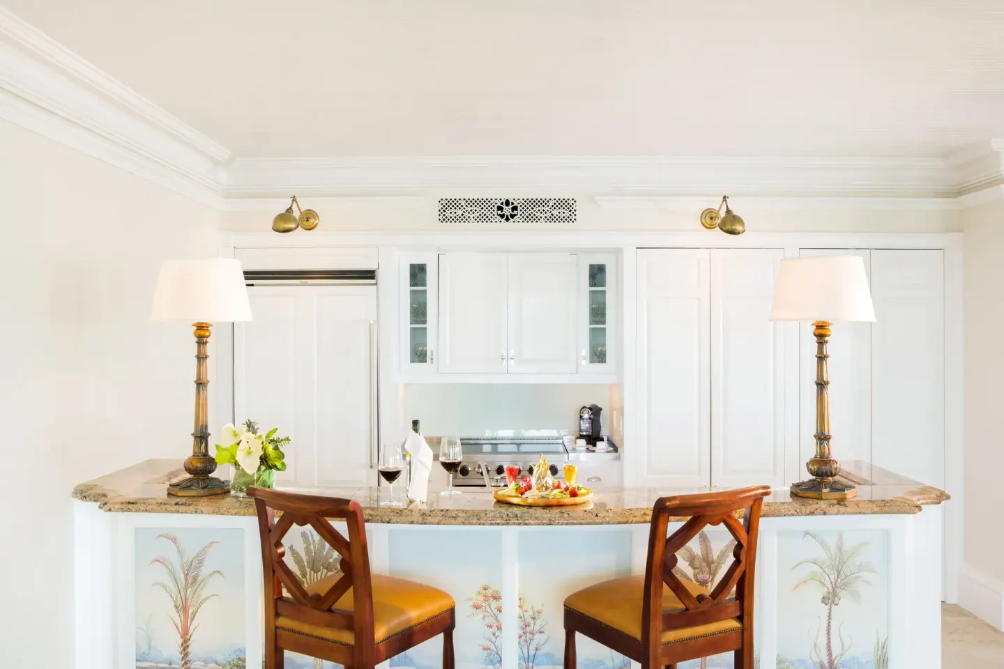 Granite kitchen bar with two chairs in a pool view suite at The Palms Turks and Caicos.