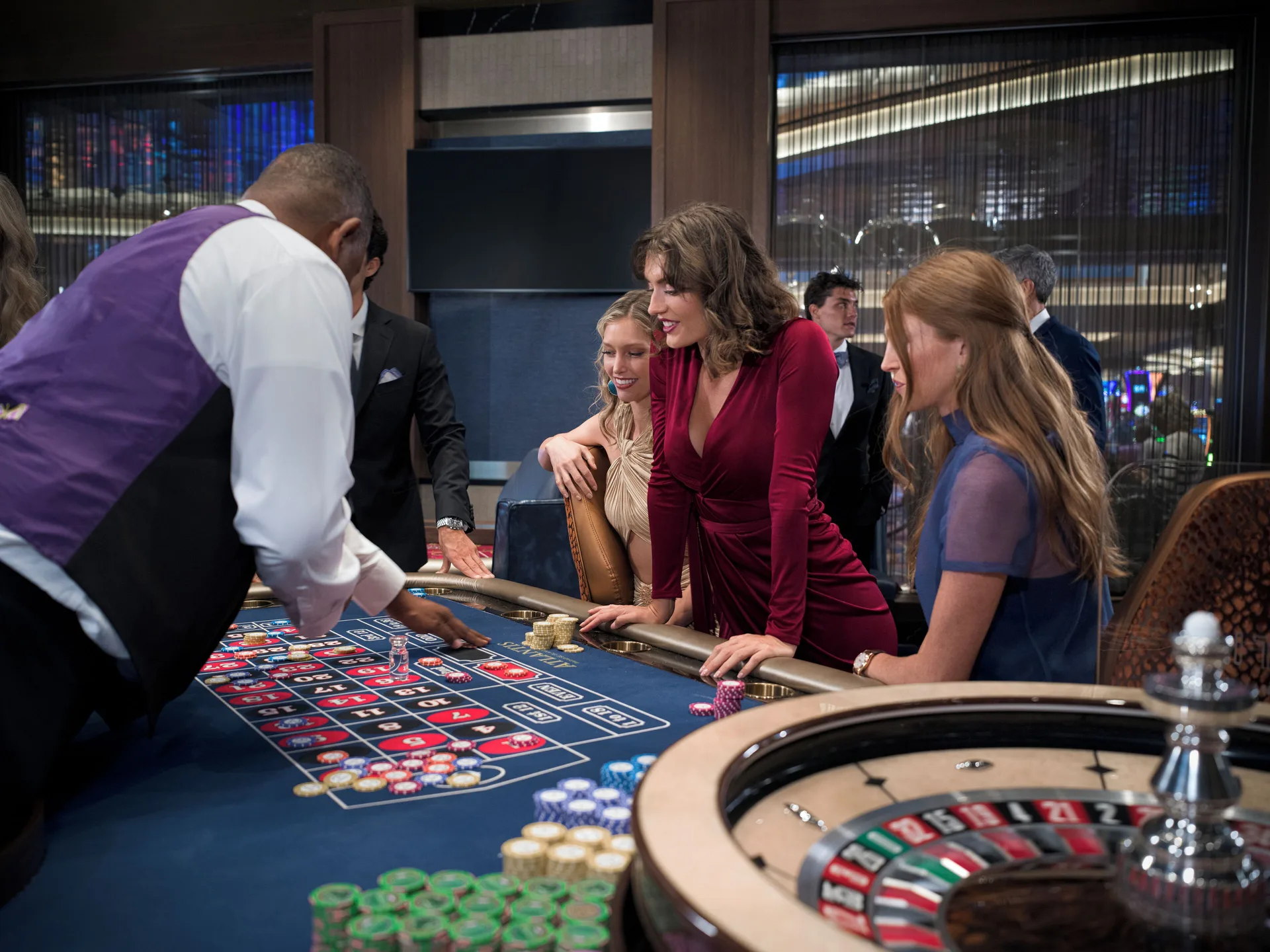 Guests gather at a roulette table in the casino at The Reef at Atlantis.