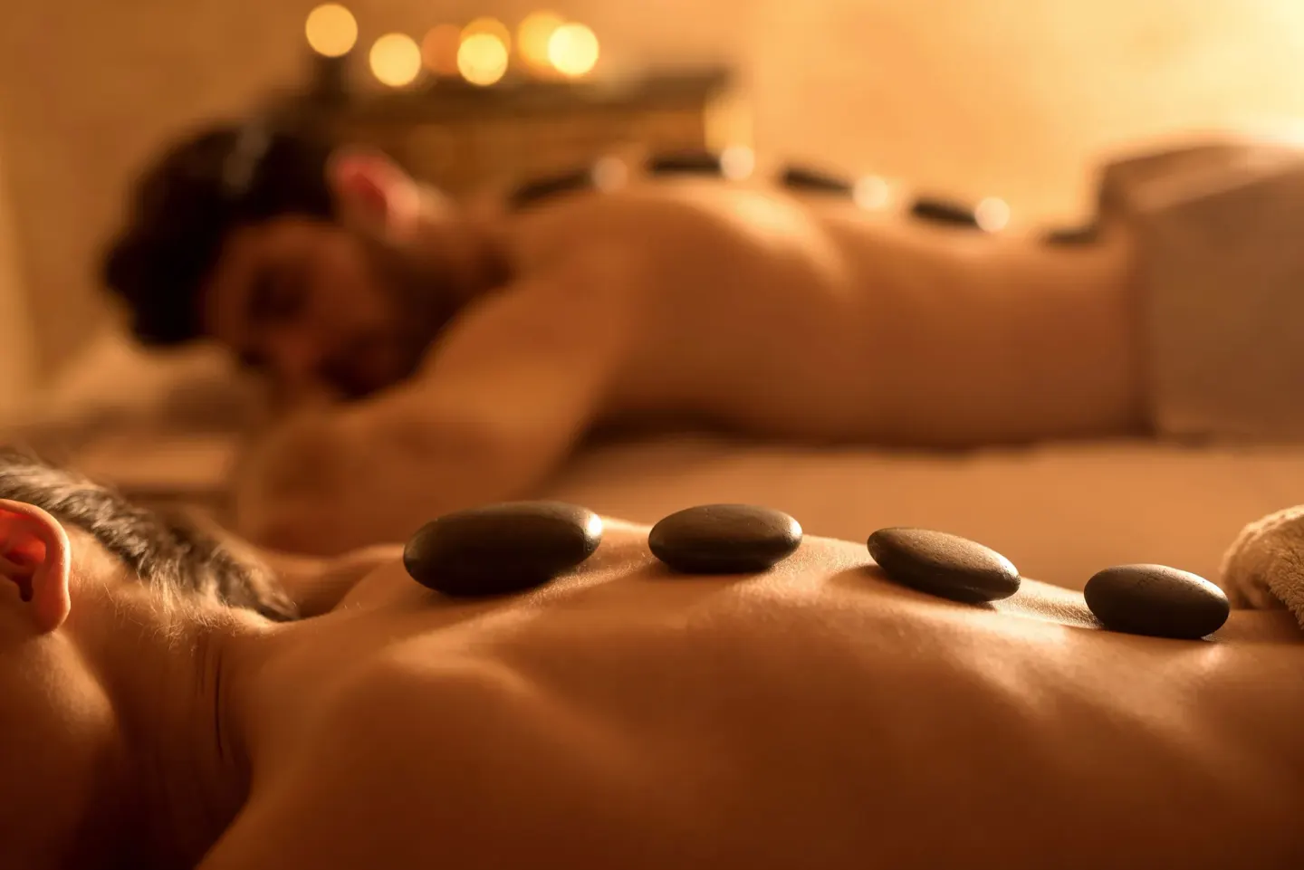 Spa guests receiving hot stone treatments at The Reef at Atlantis.