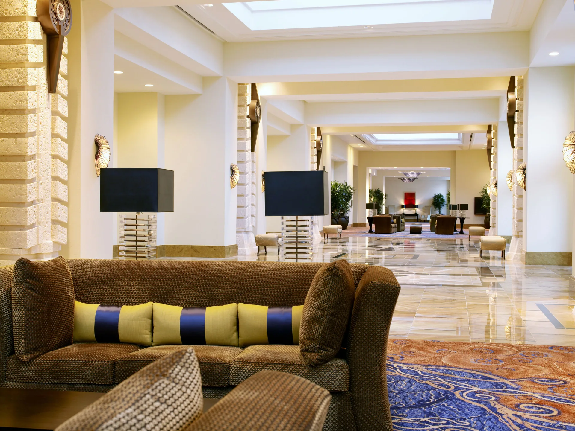 Lobby lounge seating and polished corridor inside The Reef at Atlantis.