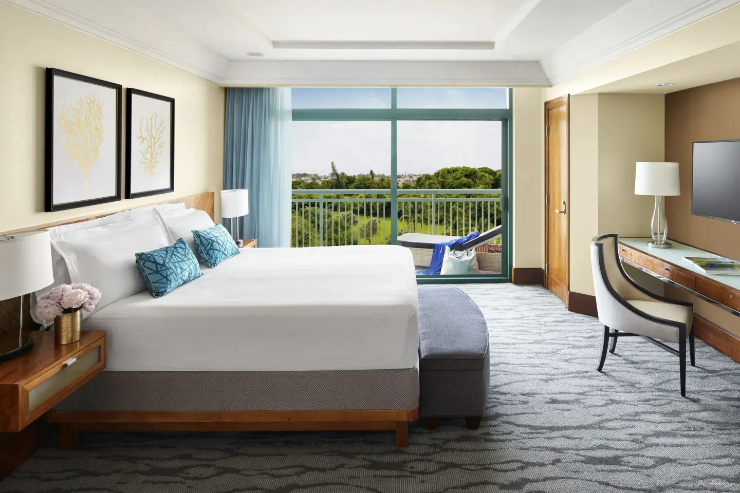 One Bedroom Terrace Suite king bed and balcony view at The Reef at Atlantis.