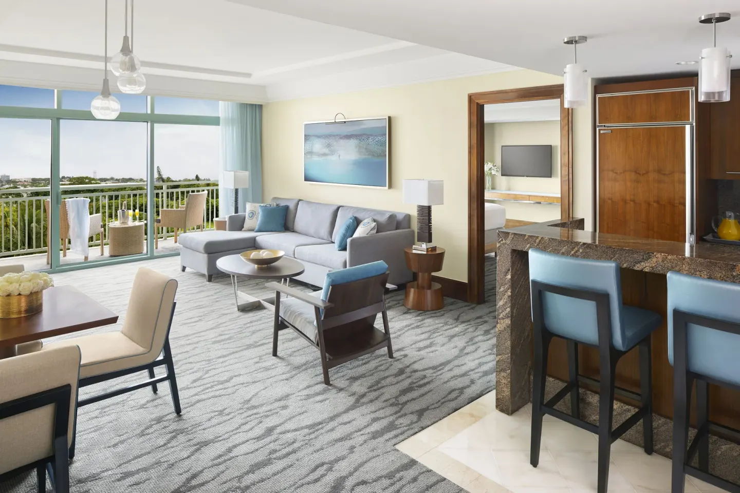 One Bedroom Terrace Suite living room with balcony and kitchenette at The Reef at Atlantis.