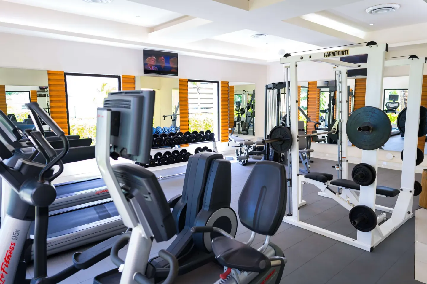 Fitness room with treadmills and weight equipment at The Reef Coco Beach Resort & Spa.