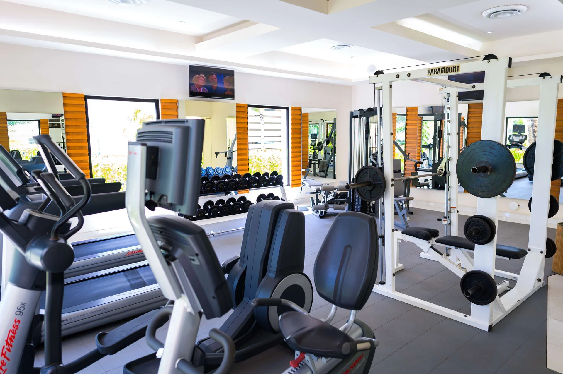 Fitness room with treadmills and weight equipment at The Reef Coco Beach Resort & Spa.