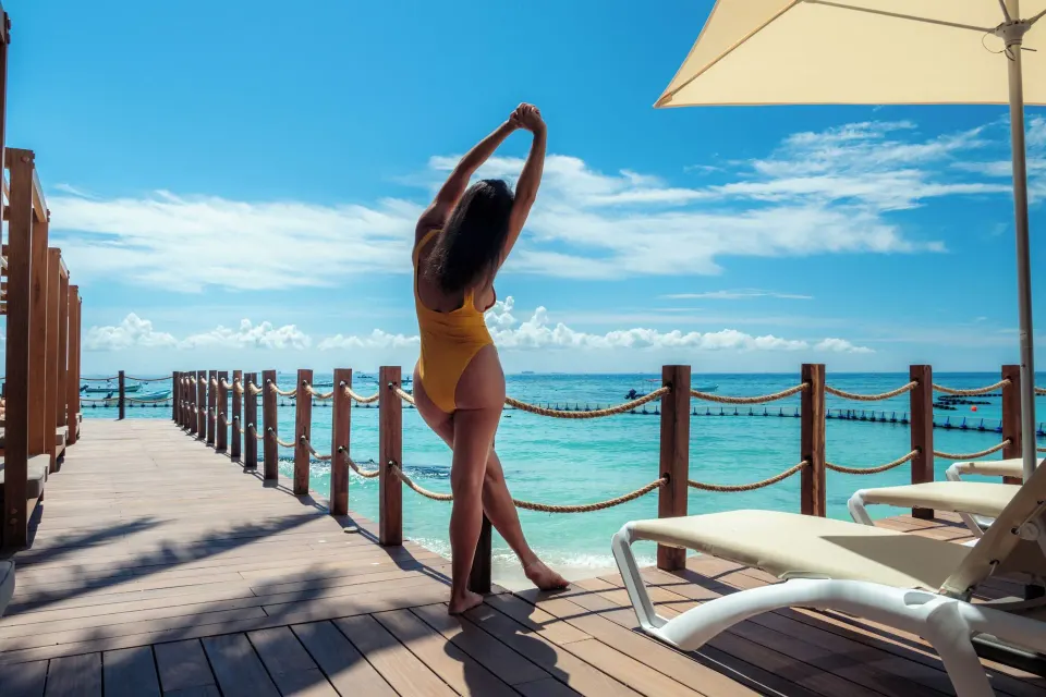 Oceanfront deck with loungers and rope railings at The Reef Coco Beach Resort & Spa.