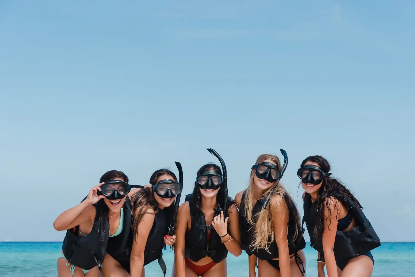 Snorkelers posing in masks by the sea at The Reef Coco Beach Resort & Spa.