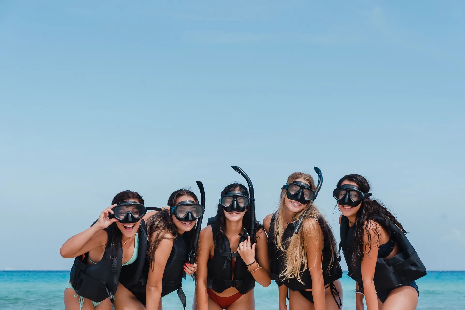 Snorkelers posing in masks by the sea at The Reef Coco Beach Resort & Spa.