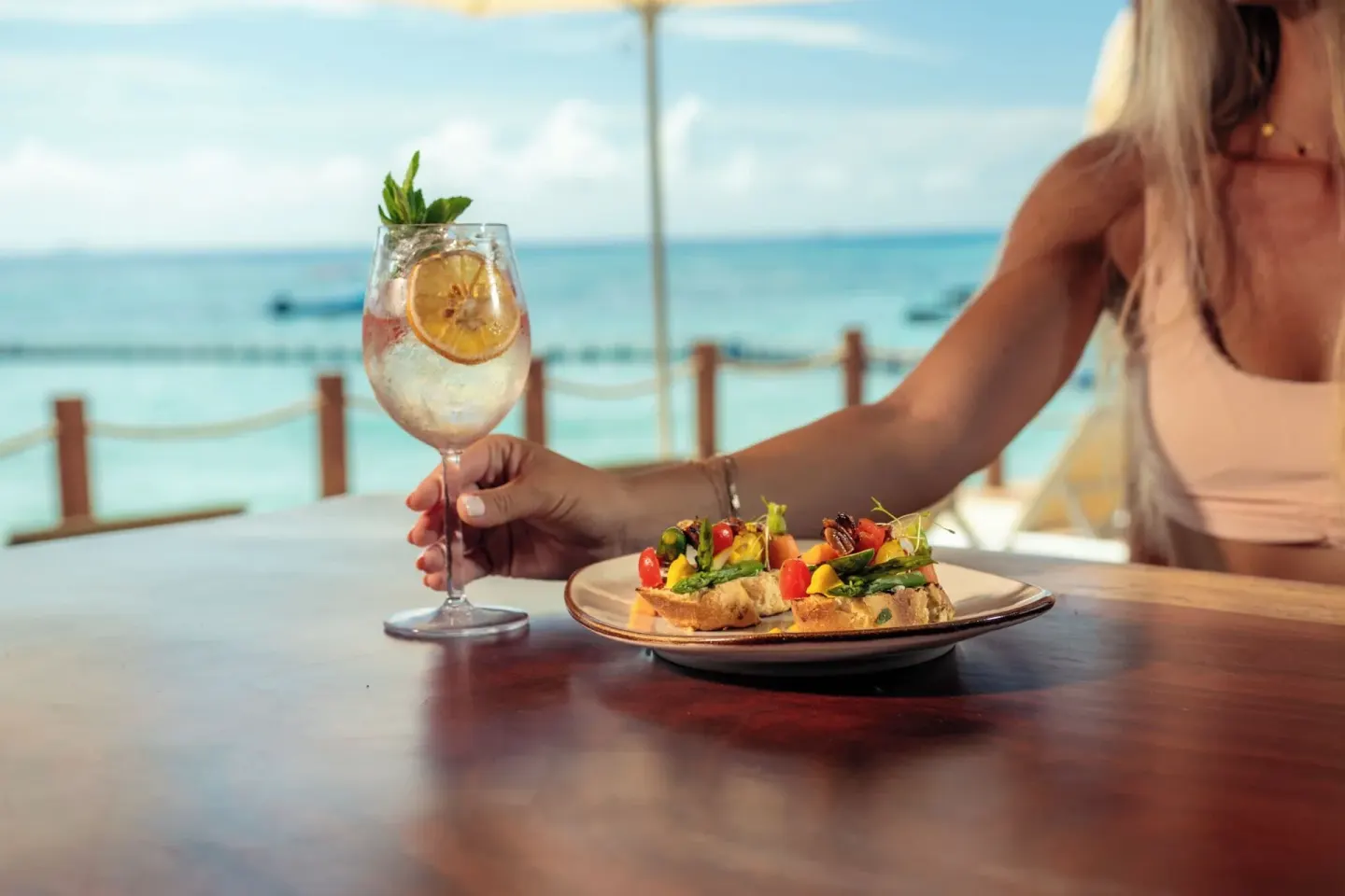 Cocktail and plated bites by the ocean at The Reef Coco Beach Resort & Spa.