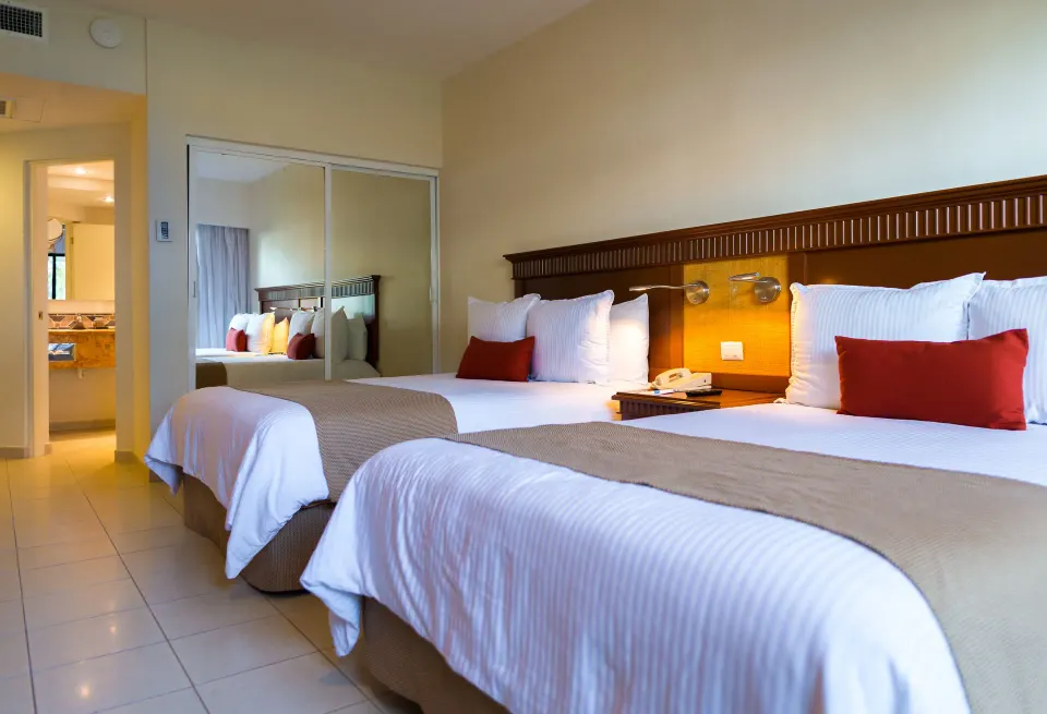 Two beds in a Premium Partial Ocean View Room at The Reef Coco Beach Resort & Spa.