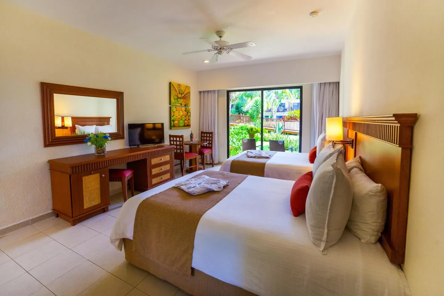 Superior Garden View Room with two beds and wood furnishings at The Reef Coco Beach Resort & Spa.