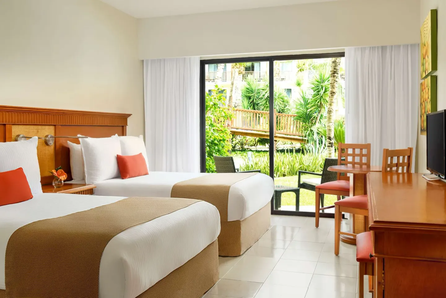 Superior Room Garden View with two beds and garden patio at The Reef Coco Beach Resort & Spa.