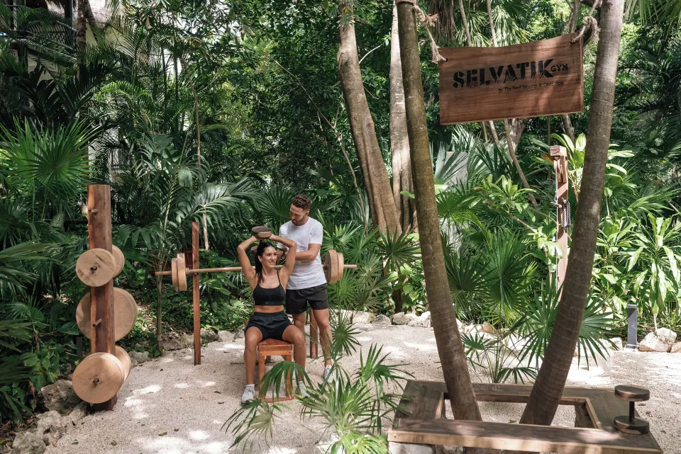 Outdoor jungle gym area with natural wooden equipment at The Reef Playacar Beach Resort & Spa