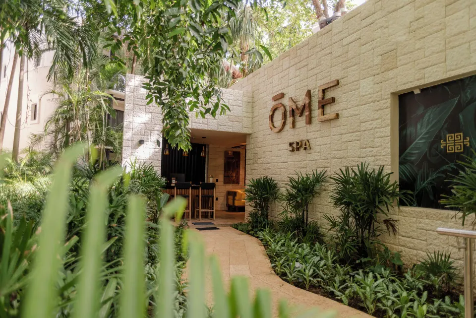 Spa entrance and garden pathway at The Reef Playacar Beach Resort & Spa