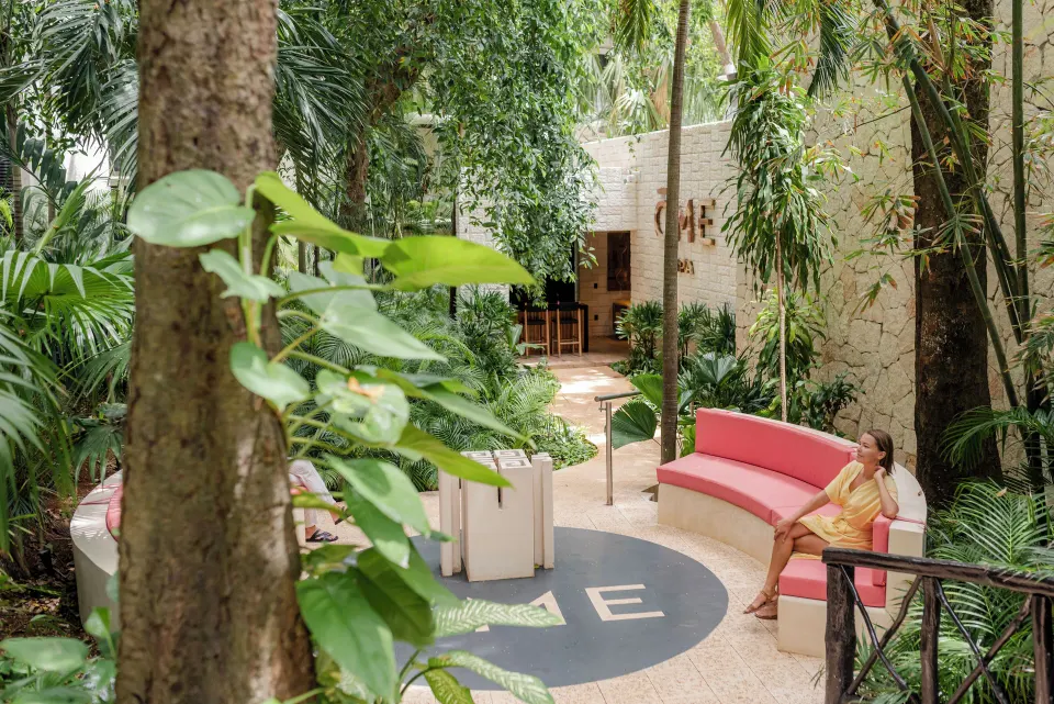 Outdoor spa seating area surrounded by plants at The Reef Playacar Beach Resort & Spa