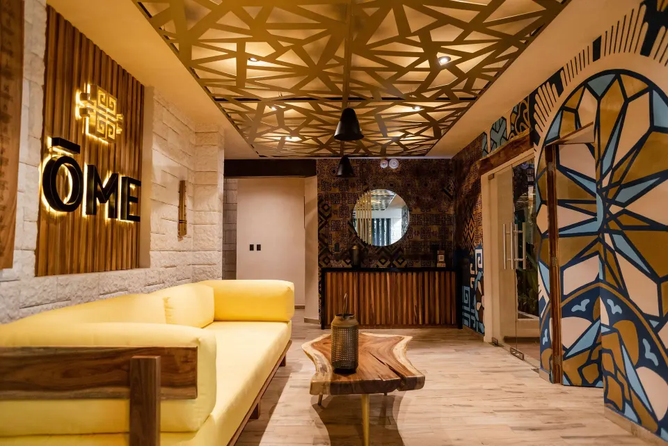 Spa reception and seating area with decorative ceiling at The Reef Playacar Beach Resort & Spa