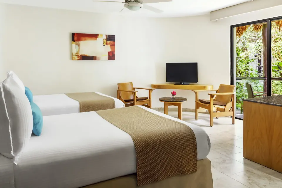Standard room with two beds and balcony greenery at The Reef Playacar Beach Resort & Spa