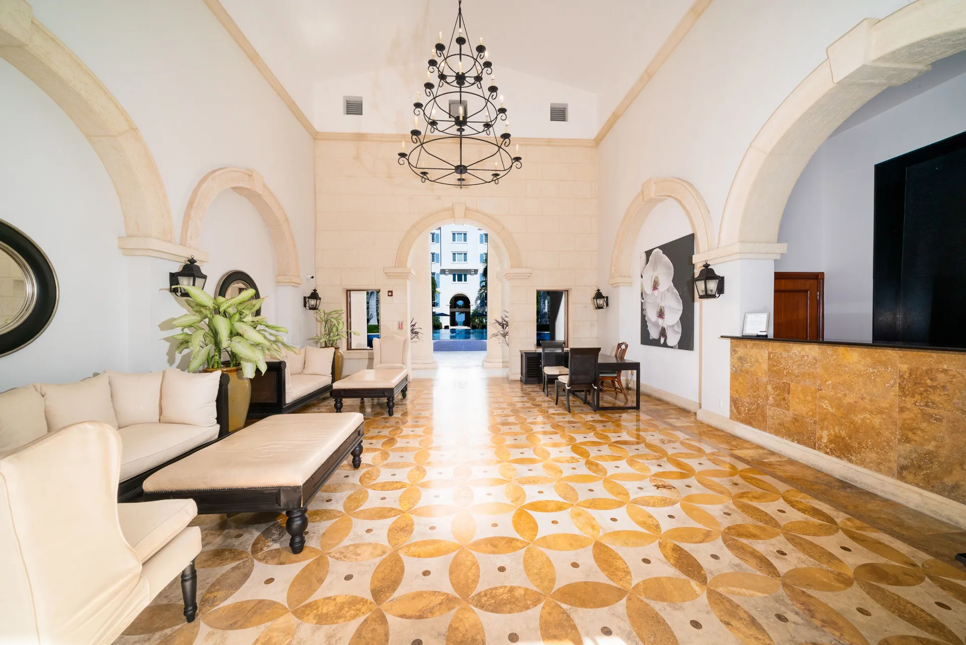 Arched lobby with lounge seating and reception desk at The Regent Grand.