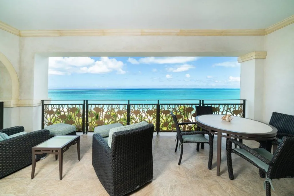 Covered oceanfront terrace with lounge and dining seating at The Regent Grand.