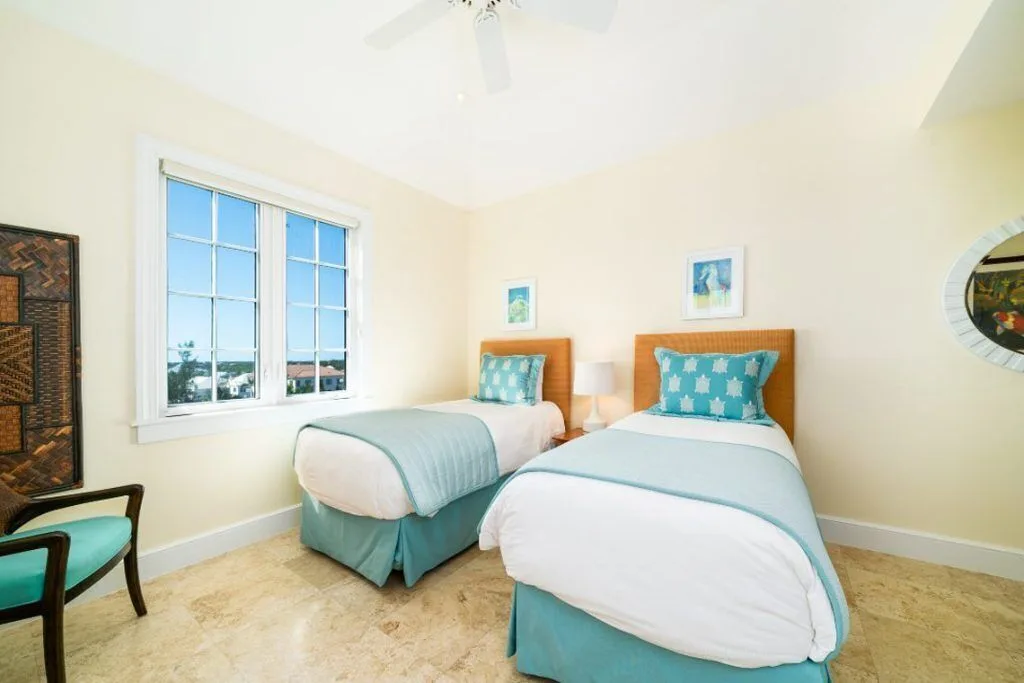Guest room with two twin beds and pale blue accents at The Regent Grand.