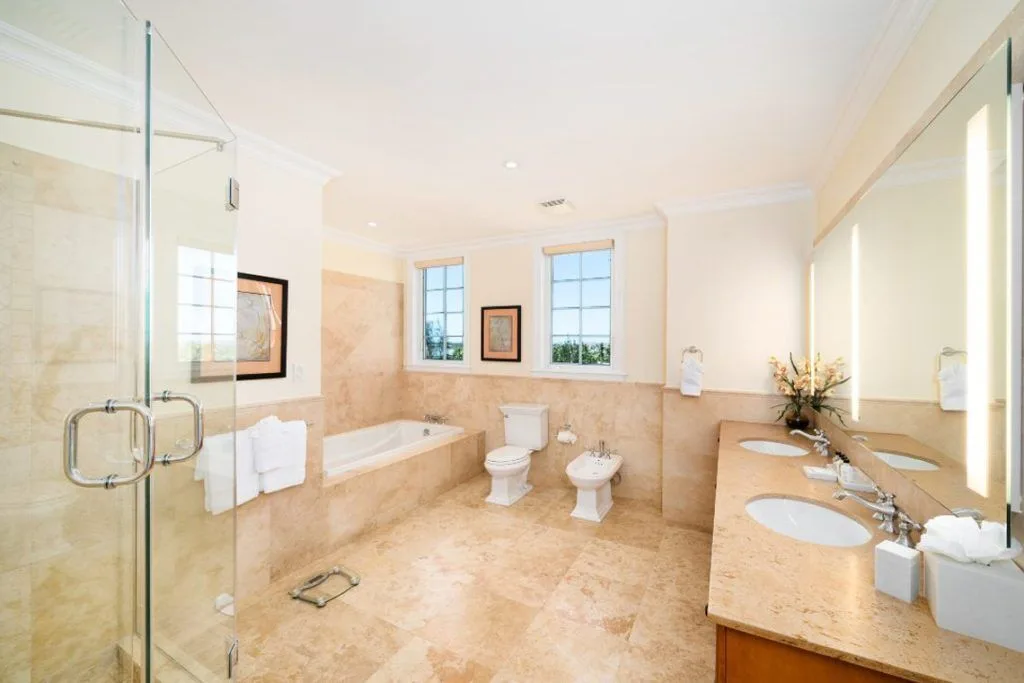 Large marble bathroom with shower, tub, and double vanity at The Regent Grand.