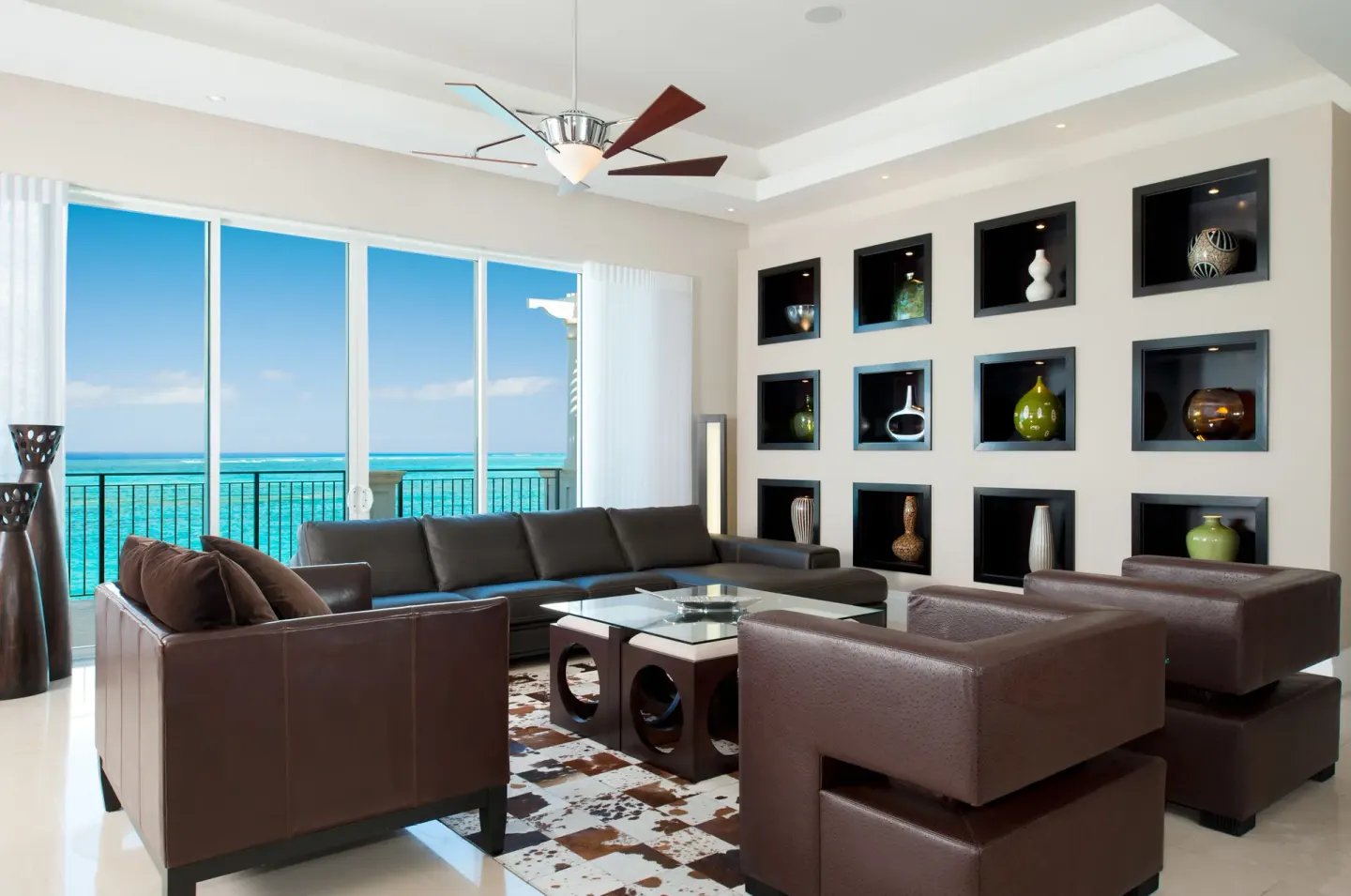 Modern ocean view living room with leather seating at The Regent Grand.