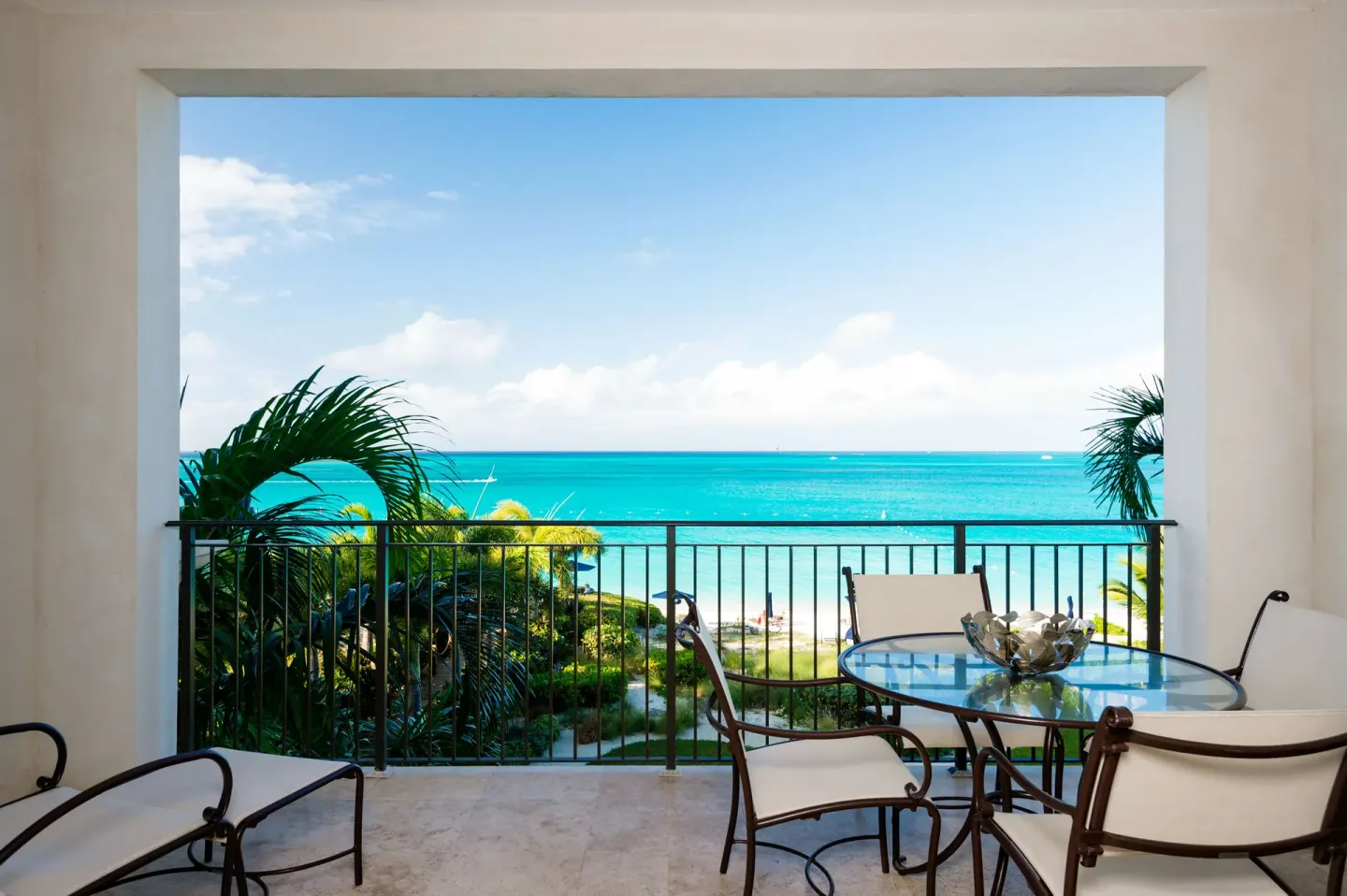 Balcony with table, chairs, and ocean view at The Regent Grand.
