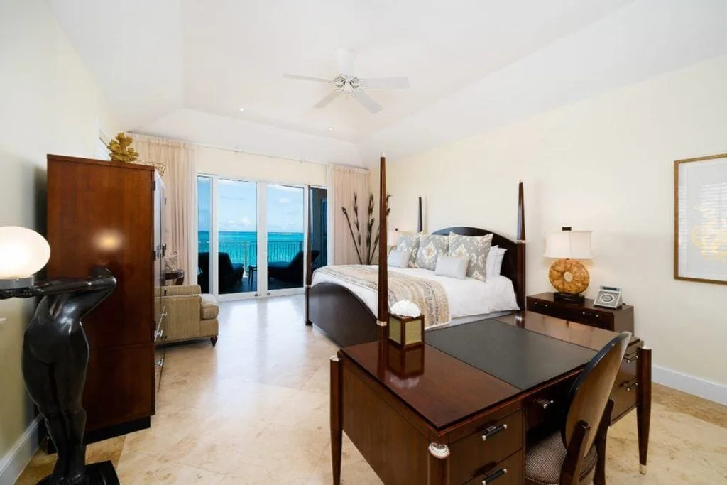 Ocean-view guest room with king bed, desk, and balcony at The Regent Grand.