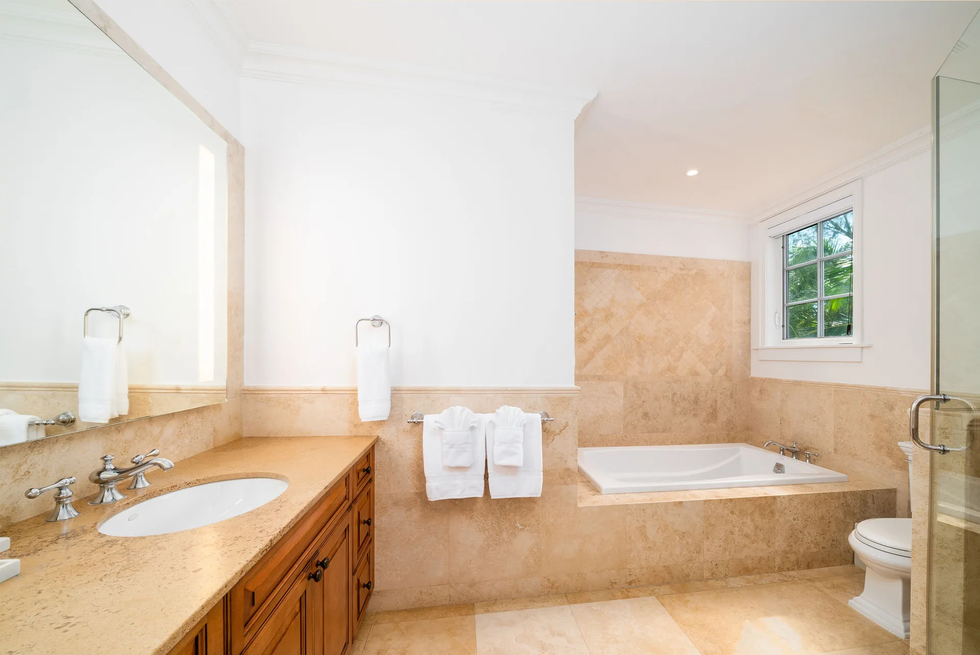 Oceanfront three-bedroom suite bathroom with vanity and tub at The Regent Grand.