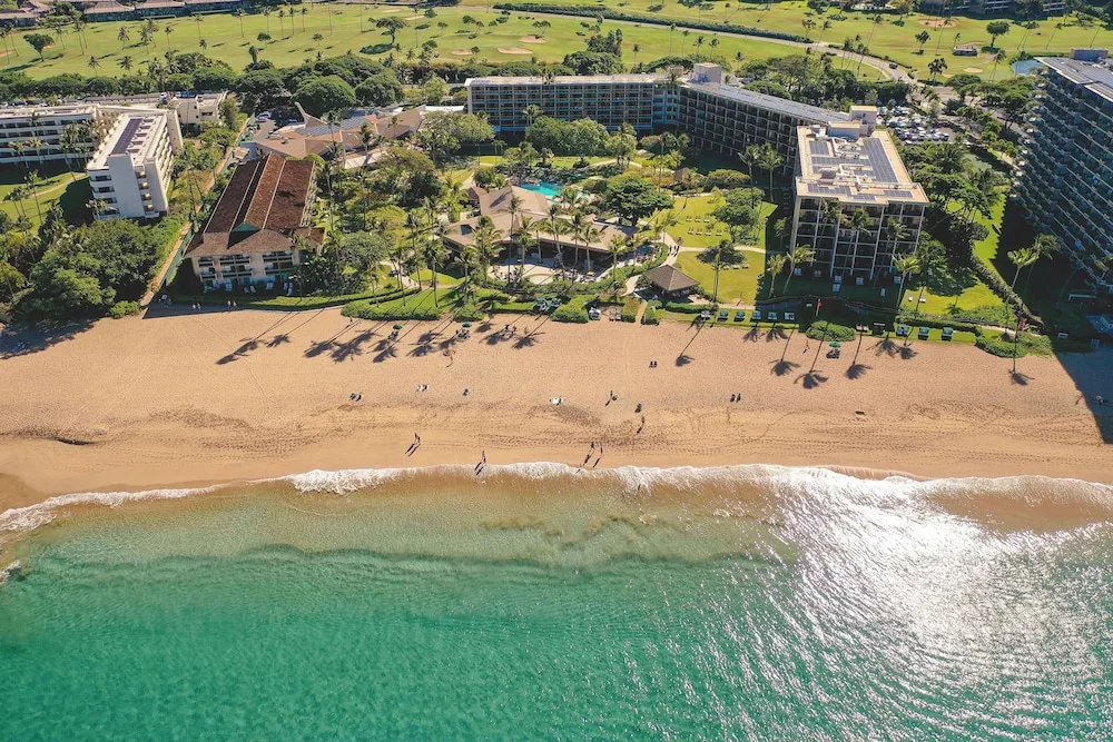 OUTRIGGER Kaanapali Beach Resort beachfront resort with oceanfront lawn and palm trees on Ka'anapali Beach, Maui.