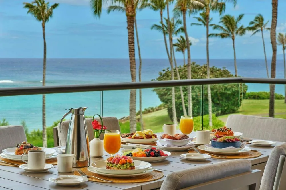 Breakfast set on an oceanfront balcony at The Resort at Kapalua Bay, Maui