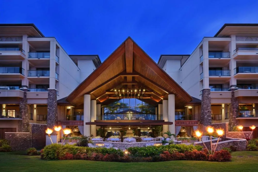 Resort entrance and porte-cochère lit at dusk at The Resort at Kapalua Bay, Maui