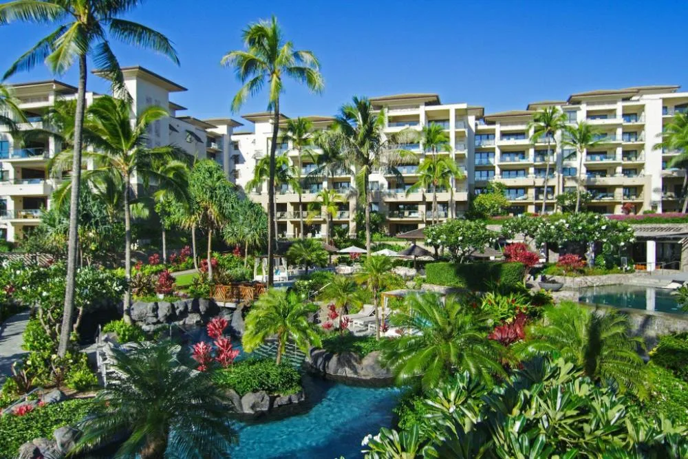 Resort grounds and multi-story buildings with lagoons and palms at The Resort at Kapalua Bay, Maui