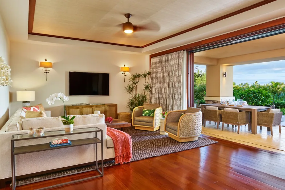 Suite living room opening to an outdoor dining lanai at The Resort at Kapalua Bay, Maui