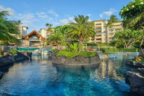 Tropical resort pool with palms and a bridge at The Resort at Kapalua Bay, Maui