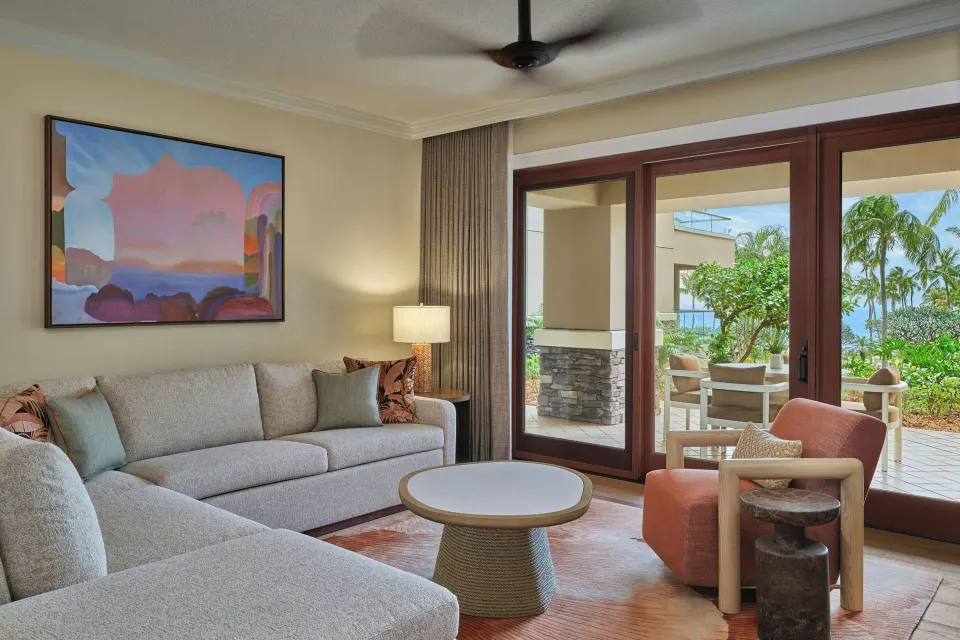 Living area of a 3 Bedroom Residence Lanai Garden View at The Resort at Kapalua Bay, Maui with sofa and patio doors