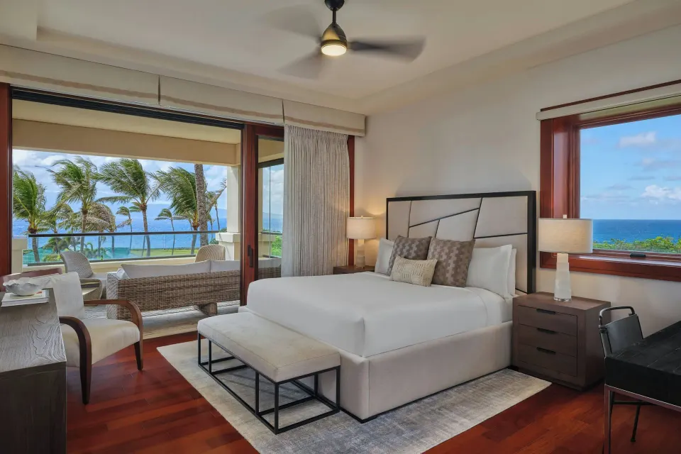 Grand room with king bed and open lanai showing ocean view at The Resort at Kapalua Bay, Maui