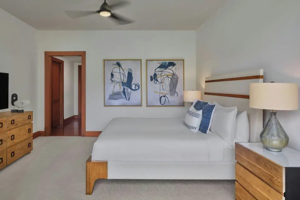 Primary bedroom with king bed and bedside lamps at The Resort at Kapalua Bay, Maui