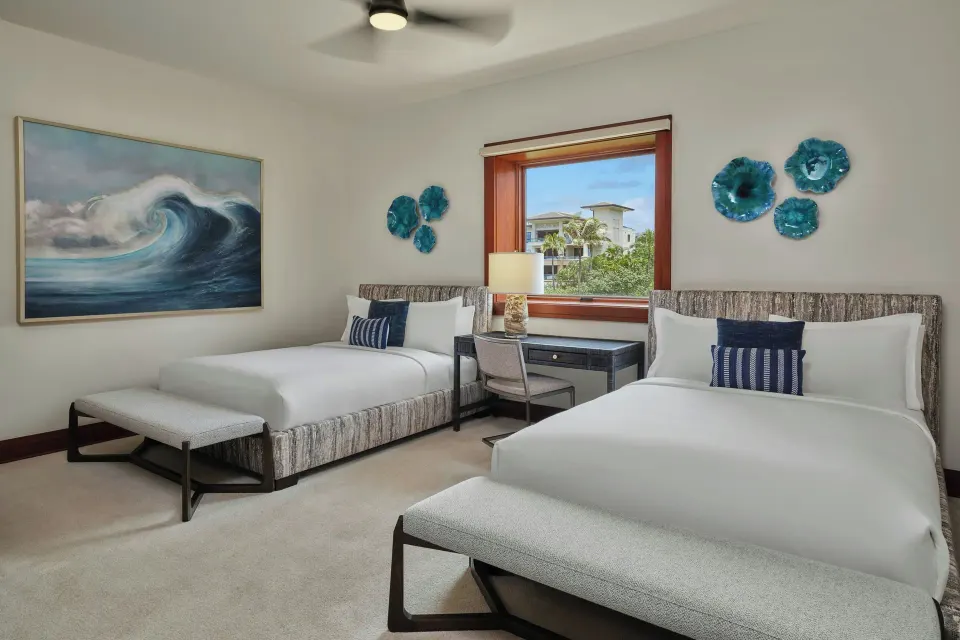 Bedroom with two twin beds and ocean-framed window at The Resort at Kapalua Bay, Maui