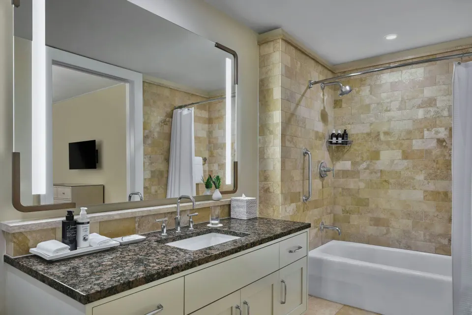 Bathroom vanity and tub in a 3 Bedroom Residence Lanai Ocean View Room at The Resort at Kapalua Bay, Maui