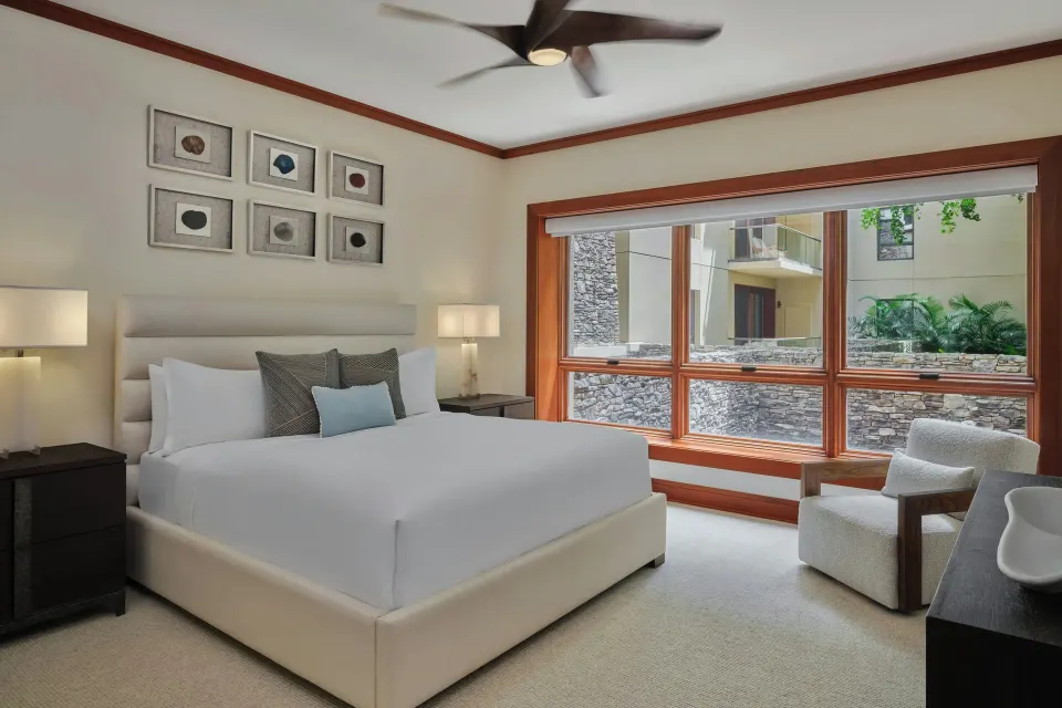 Guest bedroom with king bed and courtyard window at The Resort at Kapalua Bay, Maui