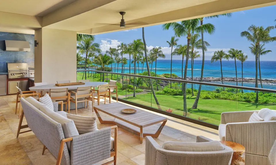 Spacious oceanfront lanai with seating and dining area at The Resort at Kapalua Bay, Maui