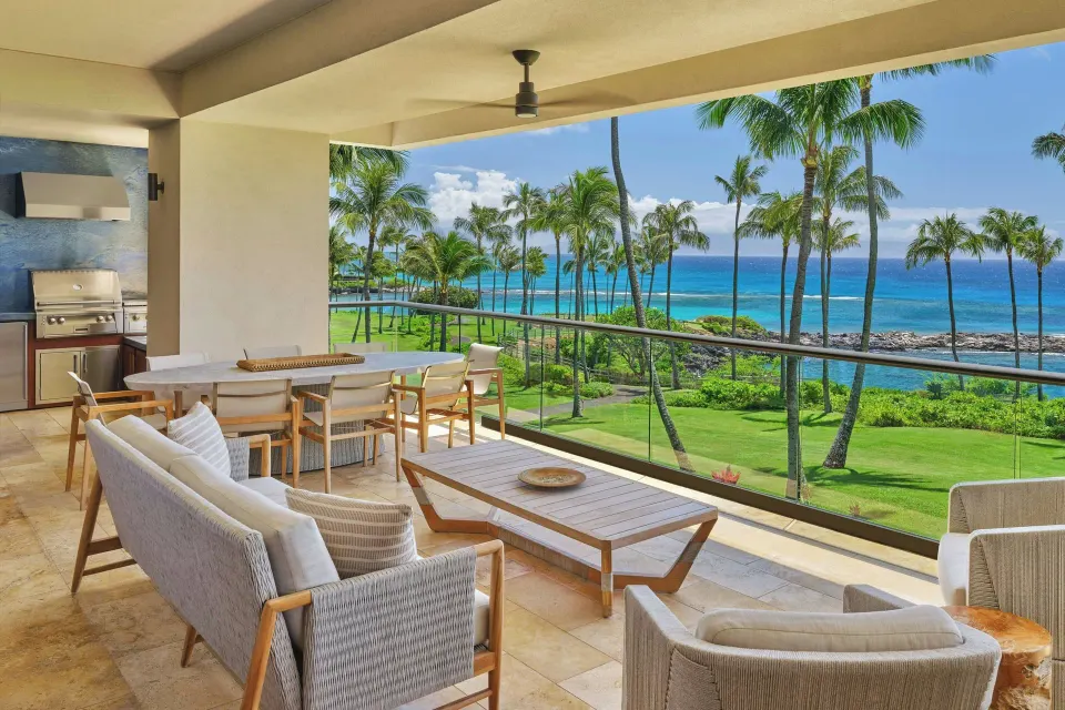 Oceanfront lanai seating with dining table and grill at The Resort at Kapalua Bay, Maui