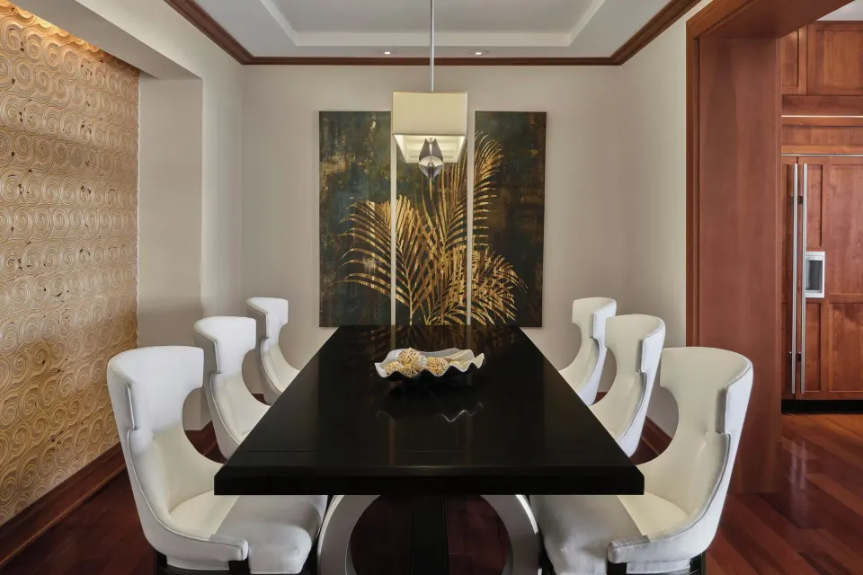 Formal dining table with eight chairs in suite at The Resort at Kapalua Bay, Maui
