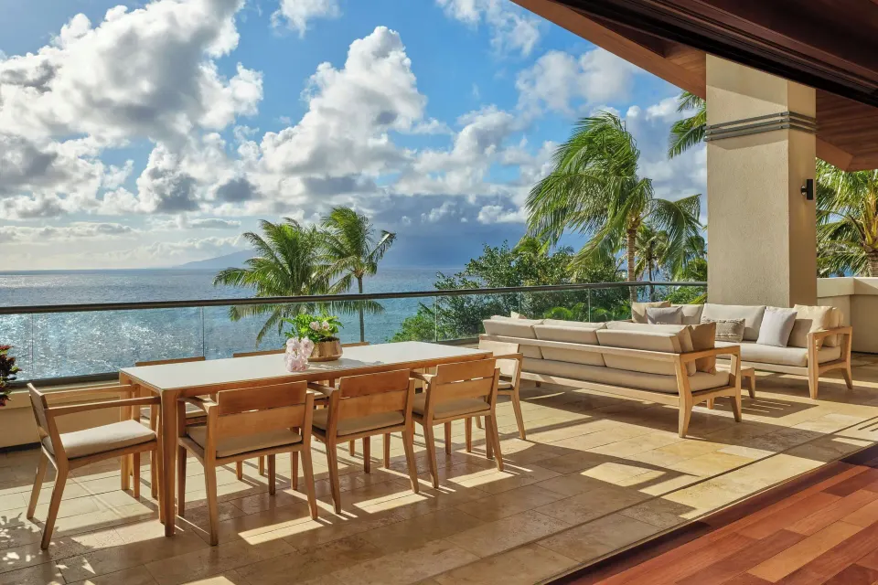 Oceanfront lanai with dining table and sofa at The Resort at Kapalua Bay, Maui