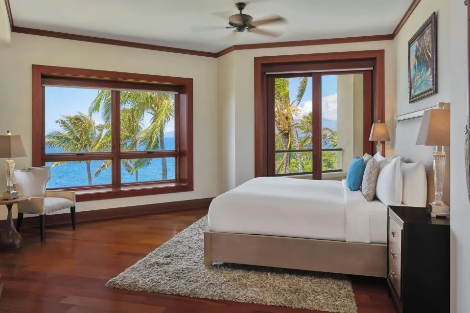 Bright king bedroom with large window and ocean view at The Resort at Kapalua Bay, Maui
