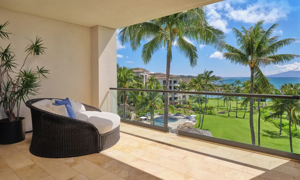 Lanai Four-Bedroom Premier private balcony with round daybed and ocean view at The Resort at Kapalua Bay, Maui