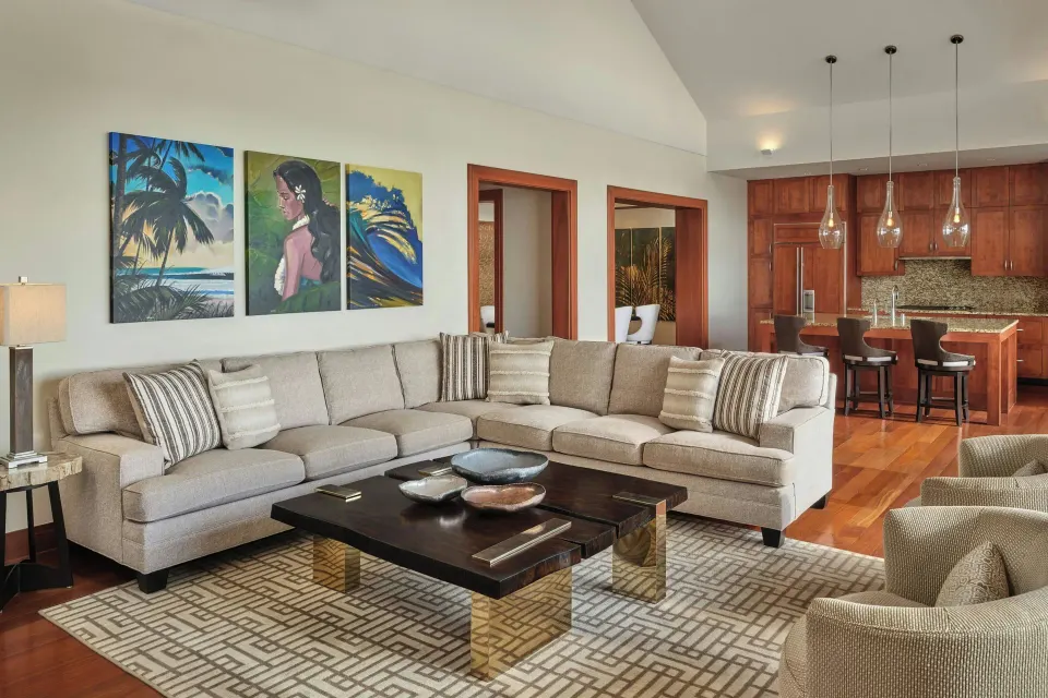 Lanai Four-Bedroom Premier living room with sectional sofa and kitchen at The Resort at Kapalua Bay, Maui