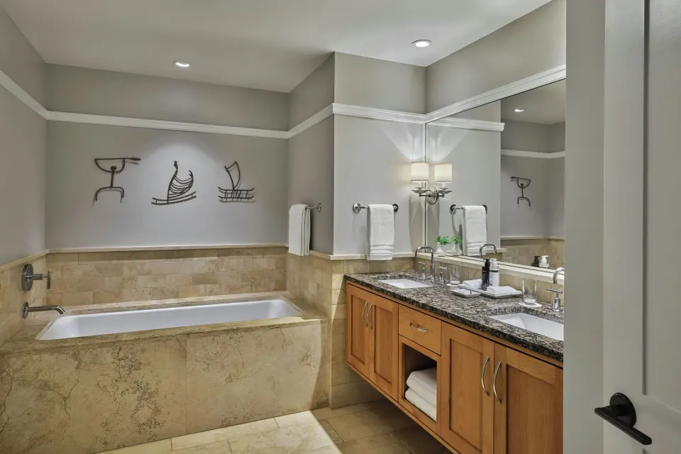 Marble tub and double vanity in a residence bathroom at The Resort at Kapalua Bay, Maui